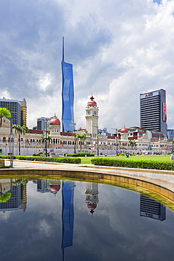 Skyscrapers reflecting in Merdeka square pond, Kuala Lumpur, Malaysia, Asia