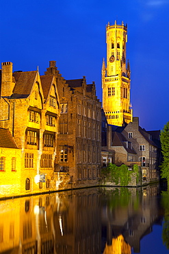 The Belfry and buildings lit up at night along a Canal in the Historic Center of Bruges, UNESCO World Heritage Site, Belgium, Europe