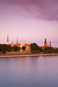 Riga Castle and the River Daugava illuminated at sunset, Riga, Latvia, Europe