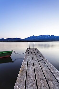 Rowing boat on Hopfensee Lake at sunset, near Fussen, Allgau, Allgau Alps, Bavaria, Germany, Europe