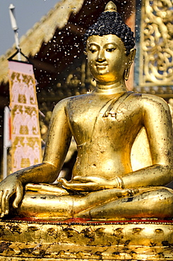 The Buddha statue at Wat Phra Singh is blessed with water during Thai New Year celebrations, Chiang Mai, Thailand.