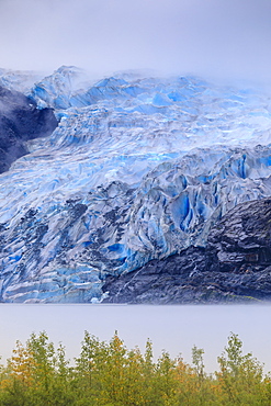 Bright blue ice of Mendenhall Glacier flowing from Juneau Ice Field, mist on Mendenhall Lake, Juneau, Alaska, United States of America, North America