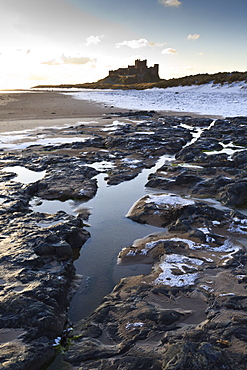 Snow on Bamburgh beach,  Bamburgh Castle, Bamburgh, Northumberland, England, United Kingdom, Europe