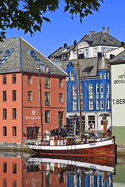 Art Nouveau buildings and reflections with boat, Alesund, More og Romsdal, Norway, Scandinavia, Europe