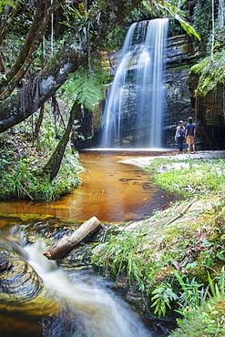 Backpackers enjoying a pristine waterfall and mountain stream in the heart of the South American rainforest, Minas Gerais, Brazil, South America