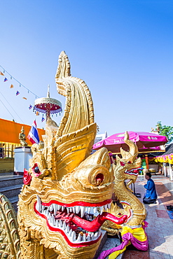 Naga head staircase and devotee at Doi Kham (Wat Phra That Doi Kham) (Temple of the Golden Mountain), Chiang Mai, Thailand, Southeast Asia, Asia