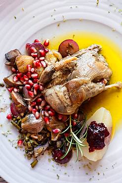 Portuguese Mediterranean dish of roast chicken in olive oil served with rosemary and pomegranate, Portugal, Europe