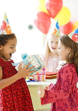 Multi-ethnic girls at birthday party