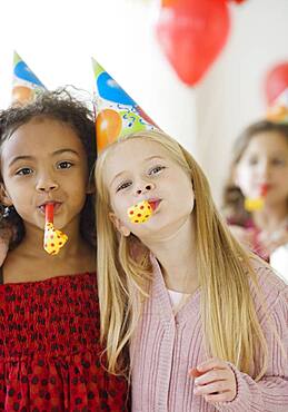 Multi-ethnic girls at birthday party