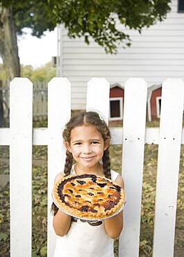 Hispanic girl holding homemade pie