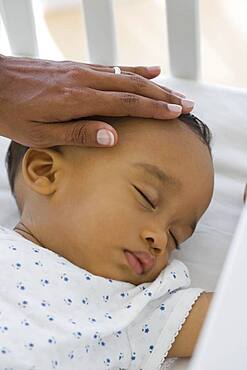 African American baby sleeping in crib