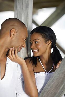 Multi-ethnic couple smiling at each other