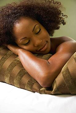 African woman laying on pillow