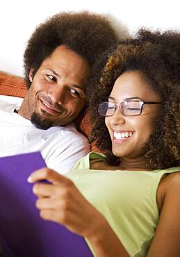 African couple reading in bed