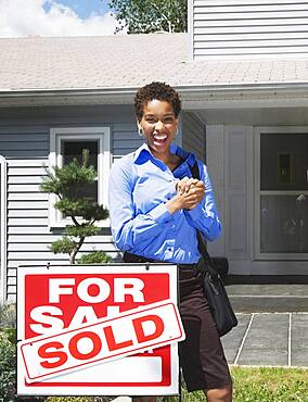 African American woman in front of new house