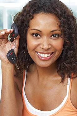 African woman holding up car keys