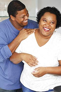 African couple hugging and laughing