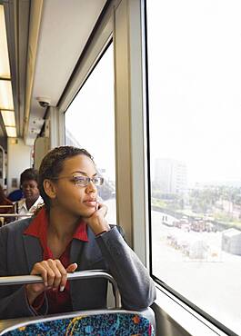 African businesswoman riding on train