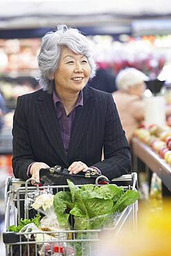 Senior Asian woman in grocery store