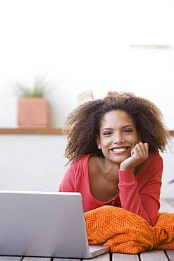 African woman next to laptop