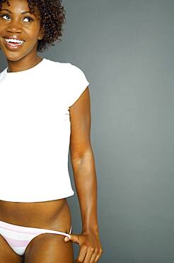 African woman wearing tee shirt and underwear