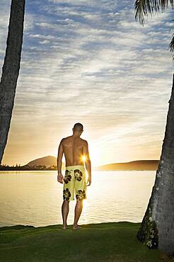 Asian man watching sunset