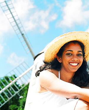 Young woman smiling with sun hat