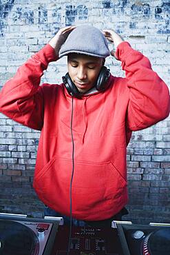 Teenage boy using turntables and headphones