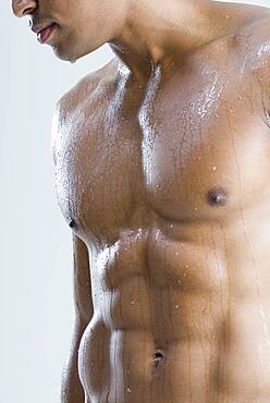 Close up of nude, wet African man