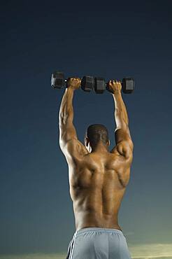 African American man lifting weights