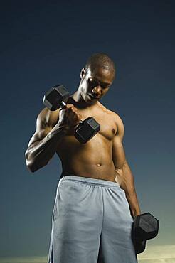 African American man lifting weights