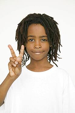 African boy making peace sign with hand