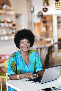 African American business owner using laptop in store