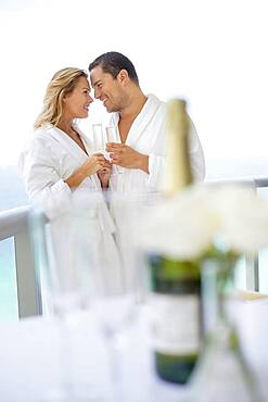 Couple drinking champagne on balcony table