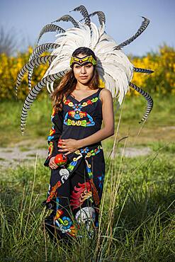 Native American woman in traditional headdress performing ceremony