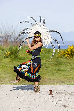 Native American woman in traditional headdress performing ceremony