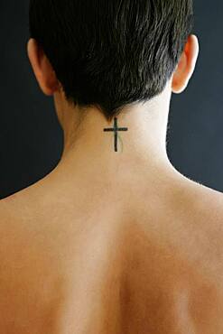 Hispanic woman with crucifix tattoo on neck