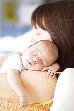 Mother holding sleeping baby