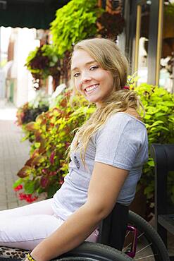 Disabled Caucasian girl smiling in wheelchair