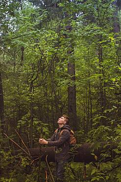 Caucasian man walking in forest