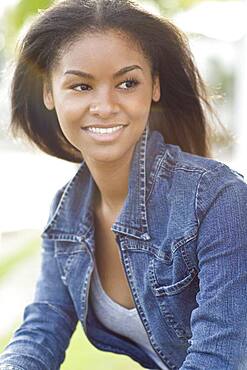 Close up of smiling Black woman sitting outdoors