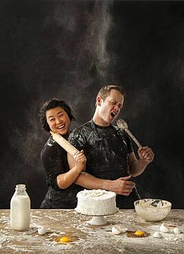 Messy couple baking cake