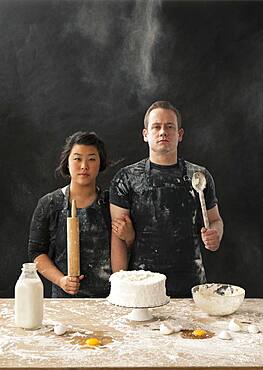 Messy couple baking cake