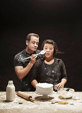 Messy couple baking cake