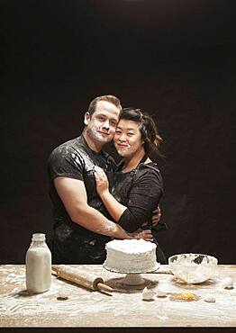 Messy couple baking cake