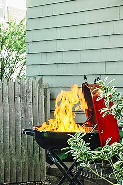 Fire burning on grill in backyard