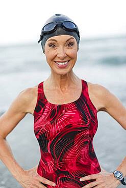 Caucasian swimmer smiling on beach