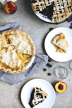 Plates of peach and blueberry pies