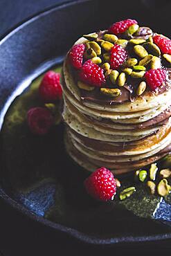 Pistachios and raspberries on pancakes