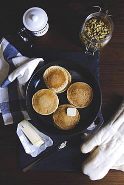 Pancake, sugar, nut and butter on table